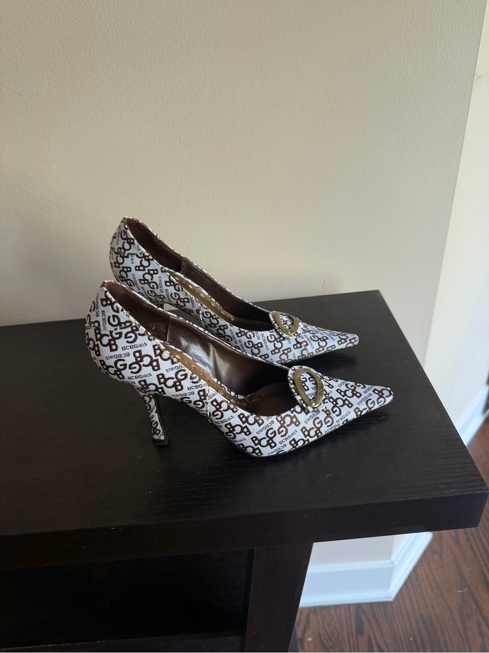 BCBGirls White and Brown Logo Pointed Toe Heels with Decorative Buckle